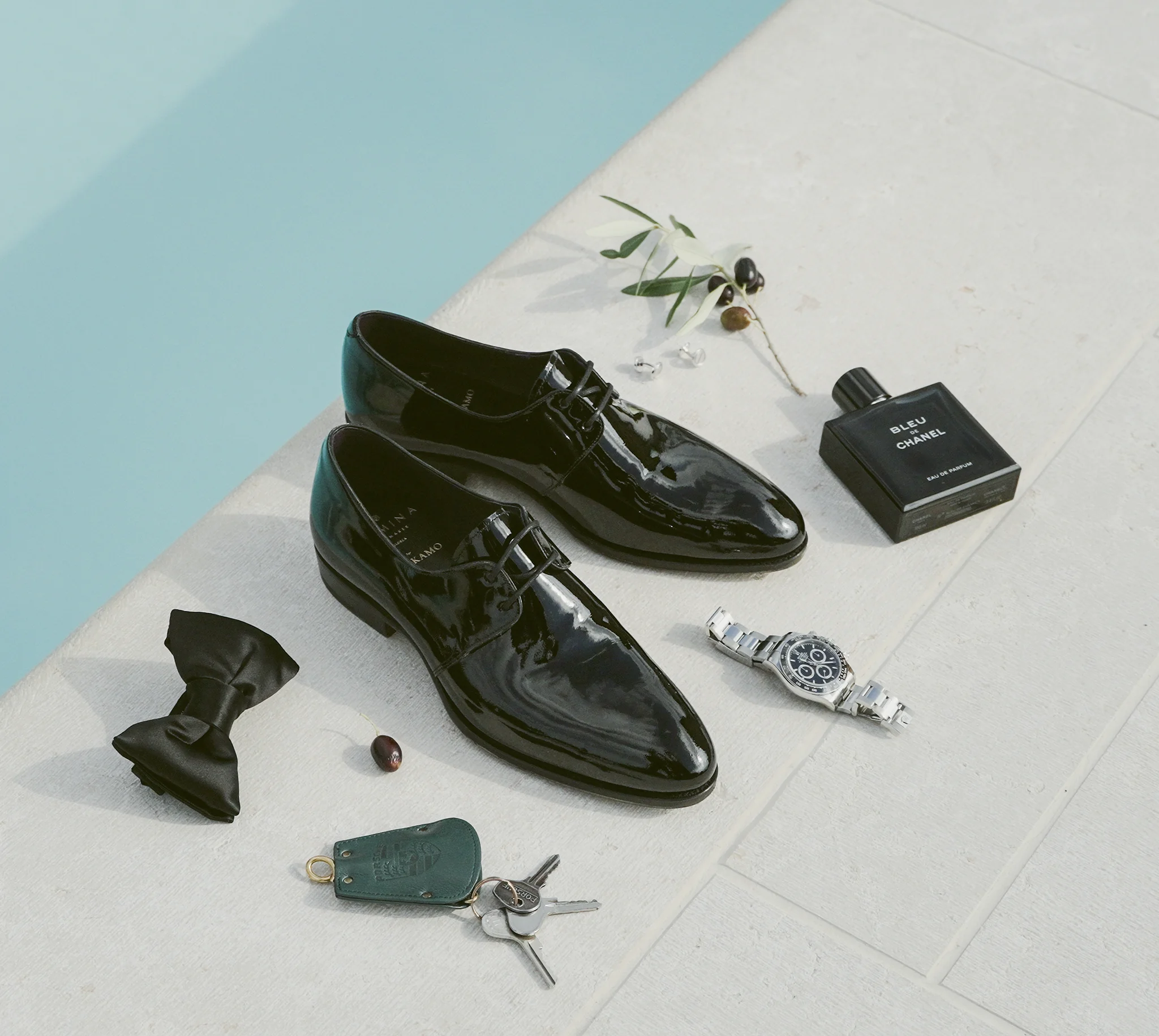 Komposition aus Schuhen und Parfum am Pool der Tenuta La Presa.