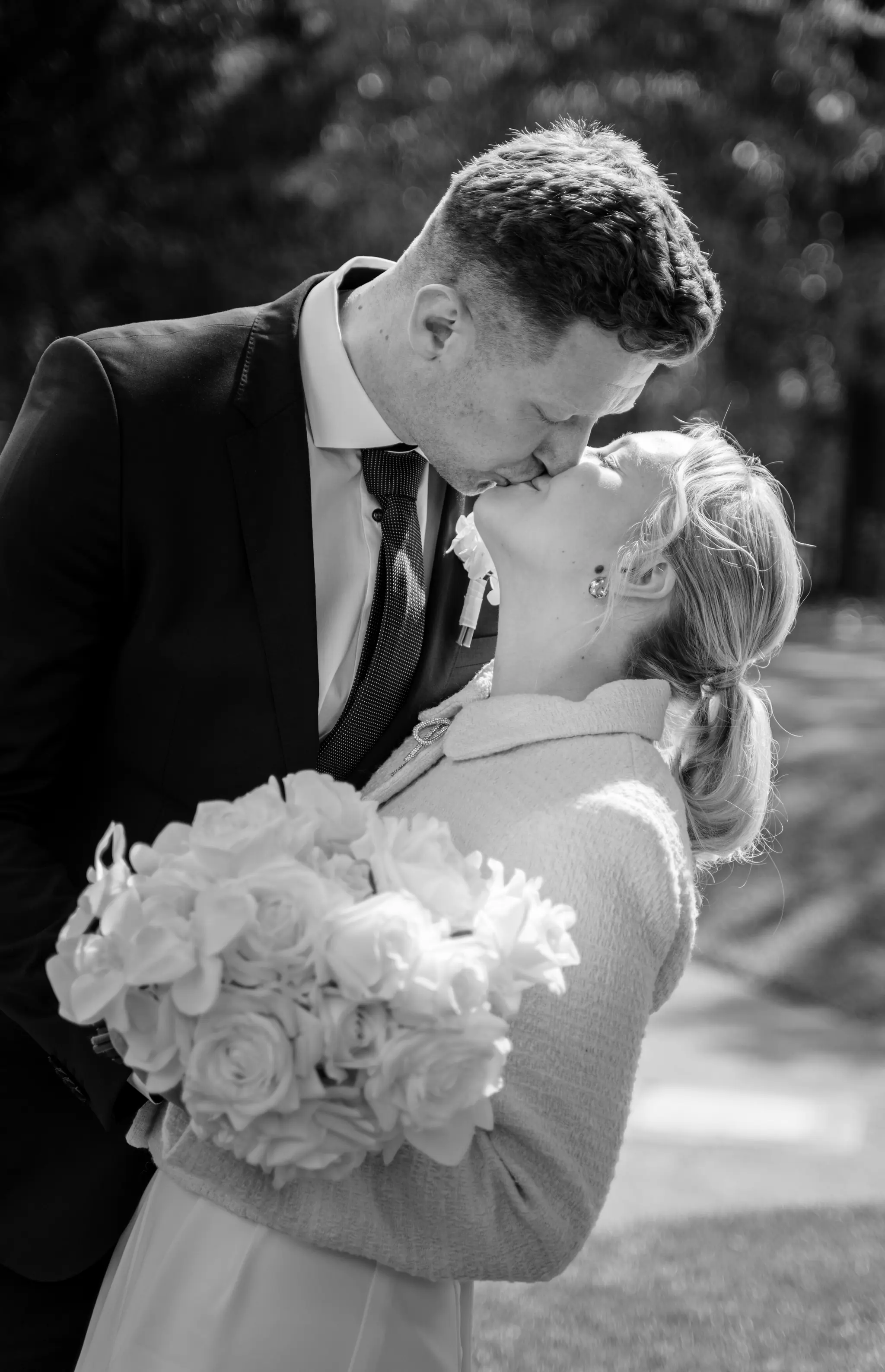 Inniger Kuss in Schwarz-Weiß: Das Brautpaar beim Shooting im weitläufigen Garten der Villa Weigang.